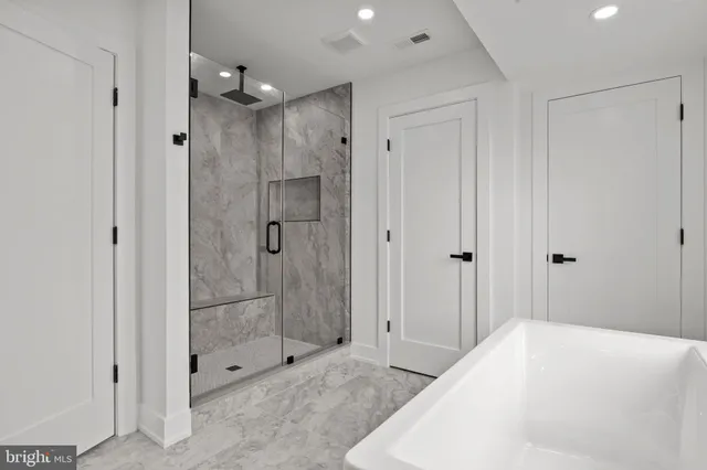 a spacious bathroom with a shower and a sink