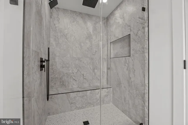 a bathroom with a glass shower door