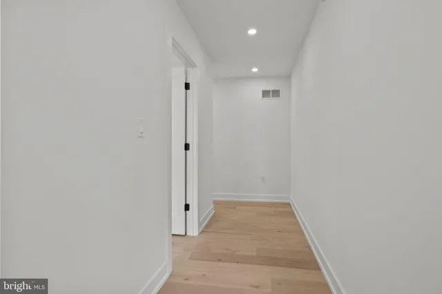 a view of a hallway with white walls