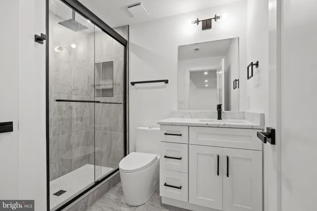 a bathroom with a shower sink and mirror