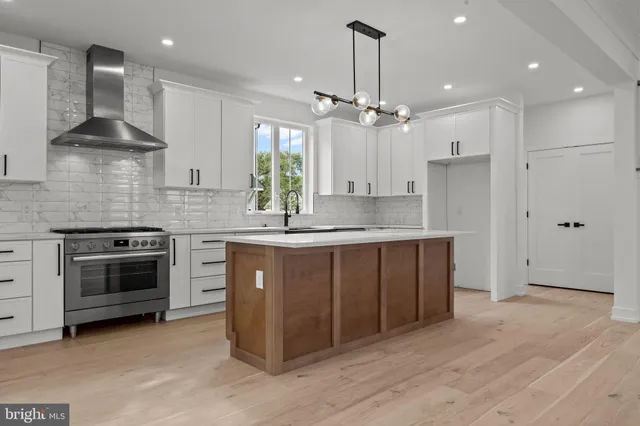 a kitchen with kitchen island granite countertop a sink cabinets and stainless steel appliances
