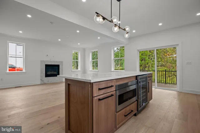 a kitchen with kitchen island granite countertop a stove and a large window