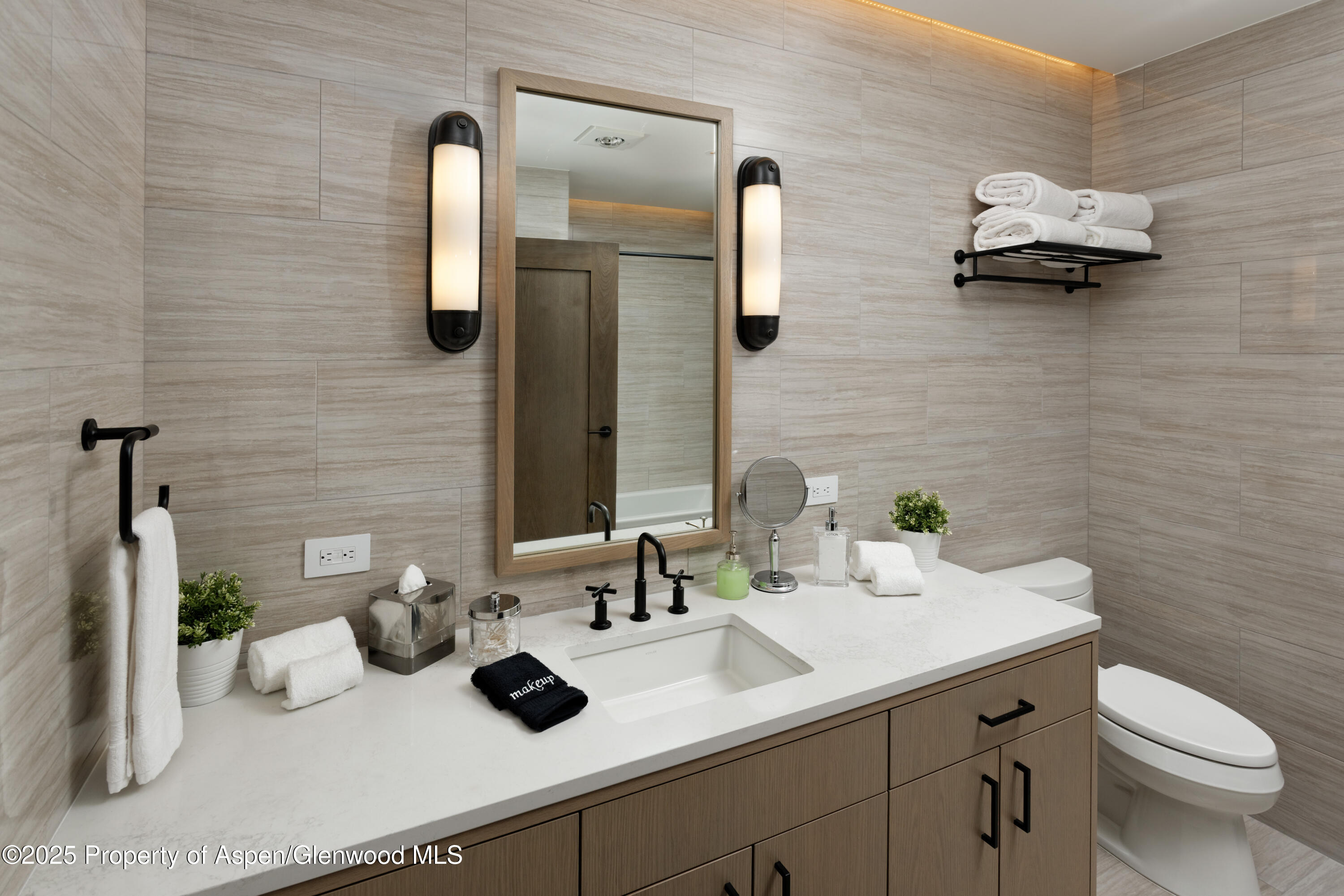 65 Wood Road, Unit 517 Snowmass Village, CO 81615 - Photo 12 of 28 a bathroom with a sink a toilet and mirror