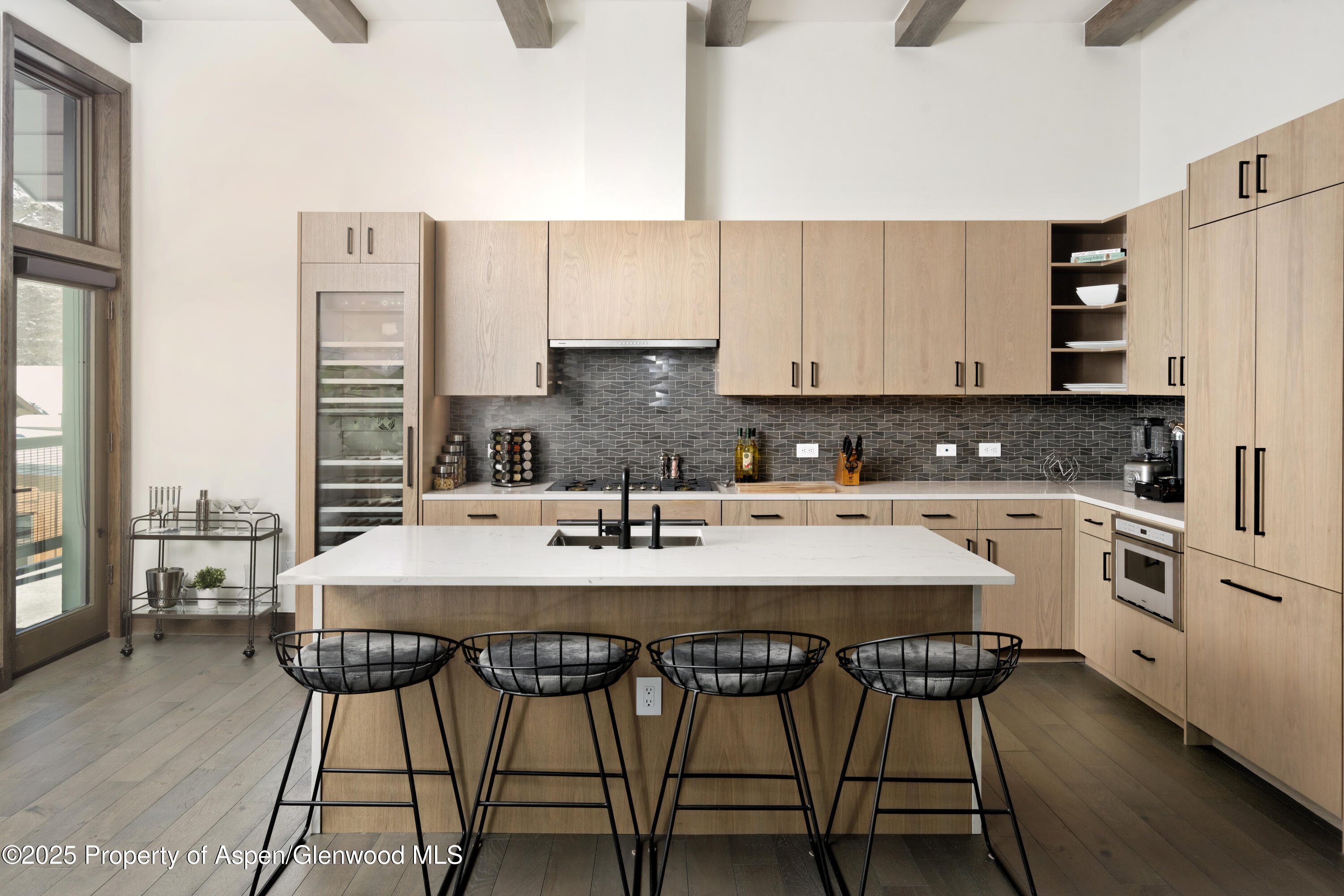 65 Wood Road, Unit 517 Snowmass Village, CO 81615 - Photo 2 of 28 a kitchen with stainless steel appliances kitchen island granite countertop a table chairs sink and cabinets