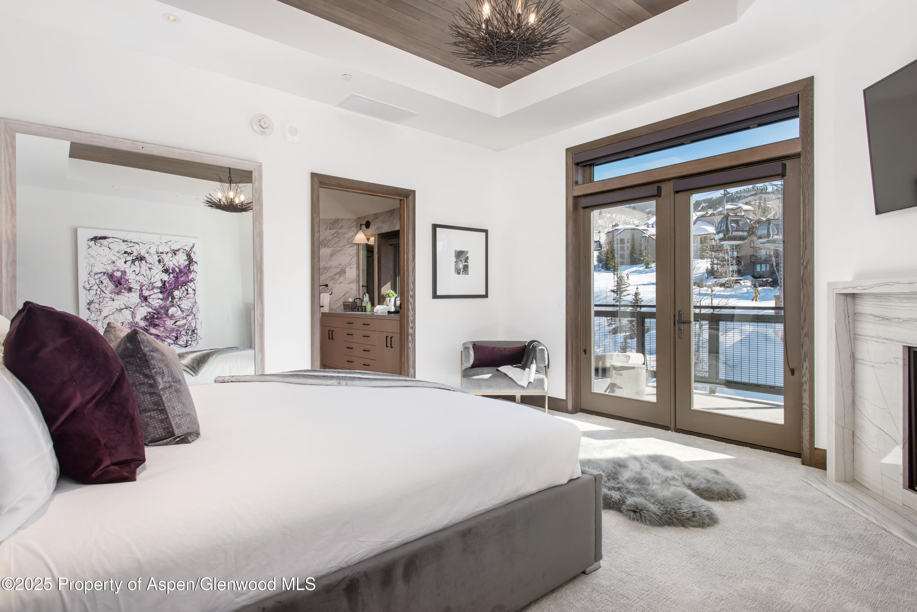 65 Wood Road, Unit 517 Snowmass Village, CO 81615 - Photo 5 of 28 a bedroom with a large bed and a large window