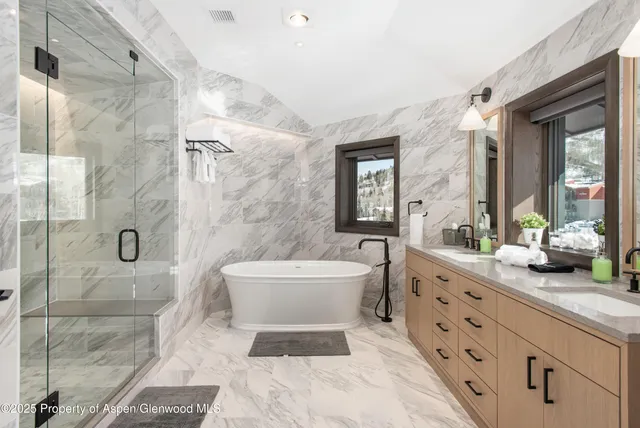 a spacious bathroom with a double vanity sink toilet and shower