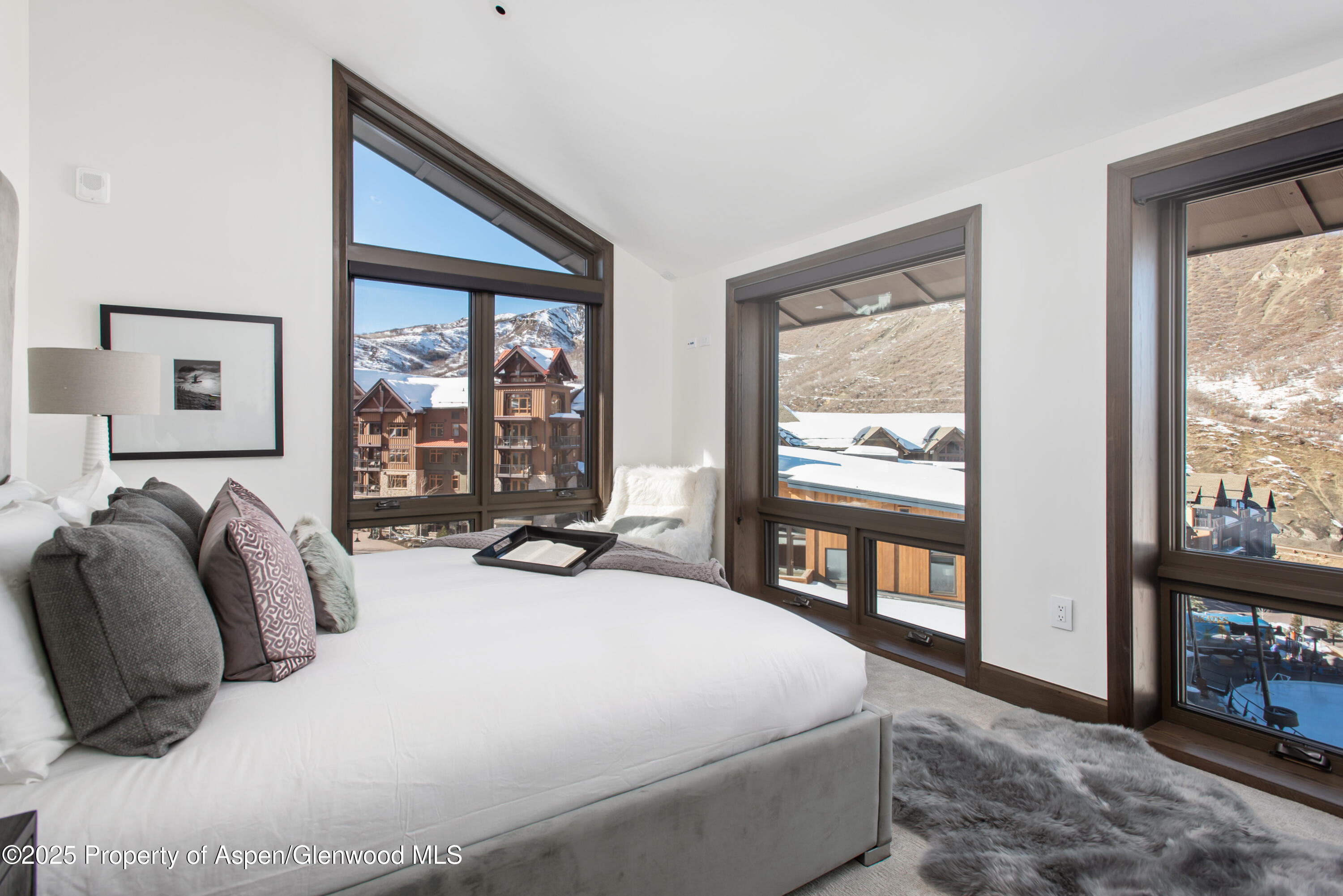 65 Wood Road, Unit 517 Snowmass Village, CO 81615 - Photo 8 of 28 a bed sitting in a bedroom next to a window