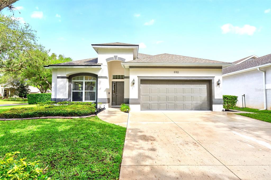 a front view of a house with a yard and garage