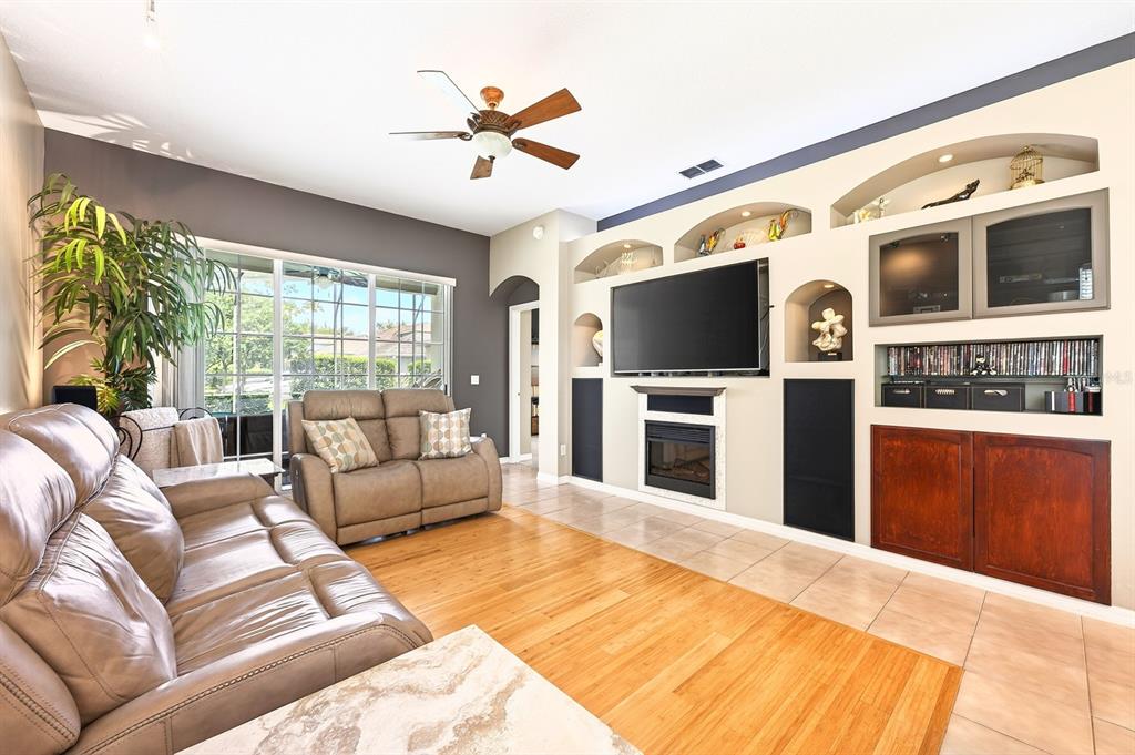990 Ridgemount Place Lake Mary, FL 32746 - Photo 15 of 46 a living room with furniture tv and a fireplace