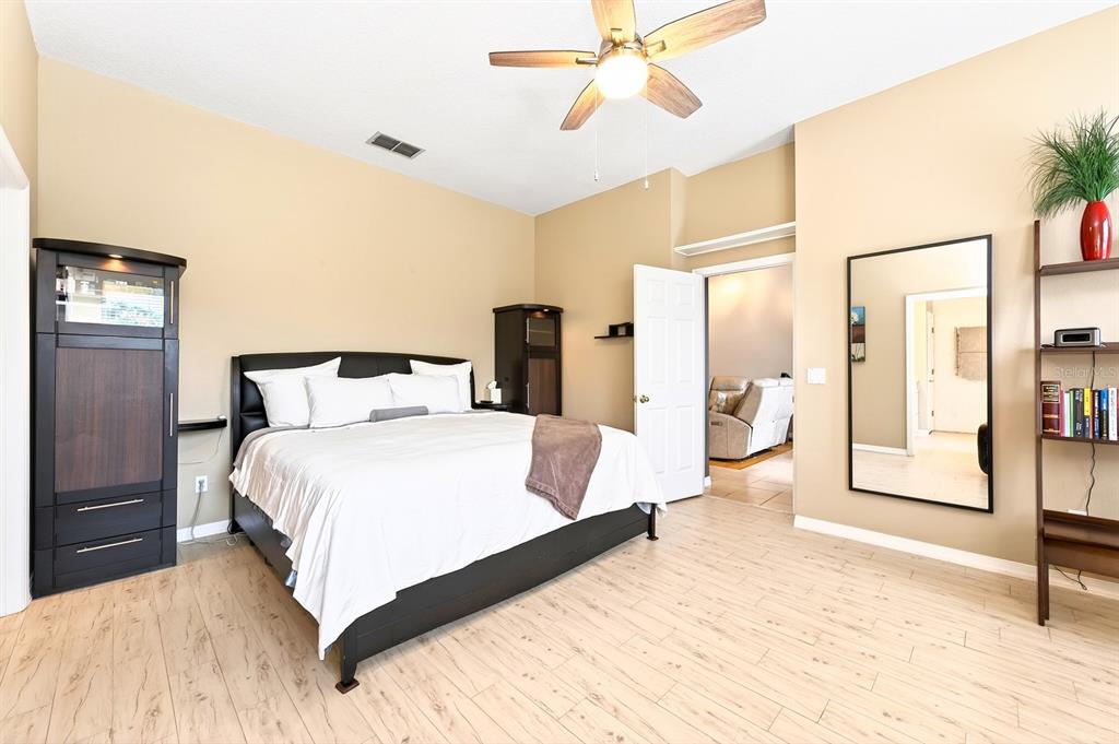 990 Ridgemount Place Lake Mary, FL 32746 - Photo 17 of 46 a bedroom with a large bed and a chandelier