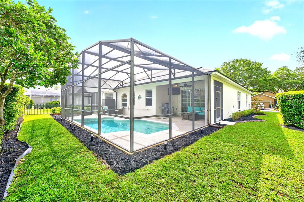 990 Ridgemount Place Lake Mary, FL 32746 - Photo 33 of 46 a view of a house with a yard and a patio