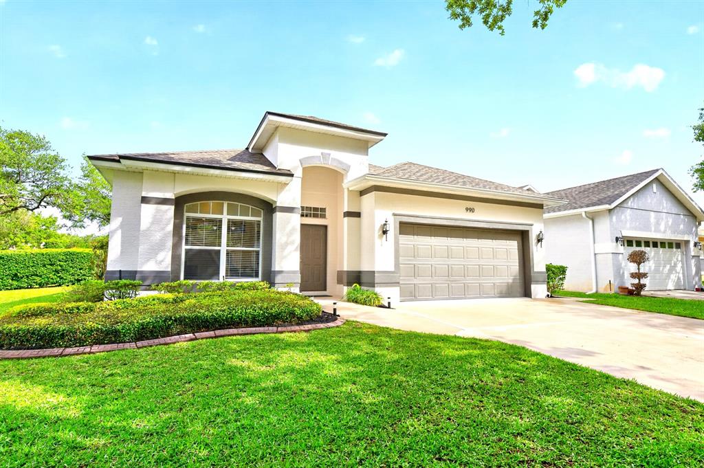 990 Ridgemount Place Lake Mary, FL 32746 - Photo 43 of 46 a front view of a house with a yard and garage