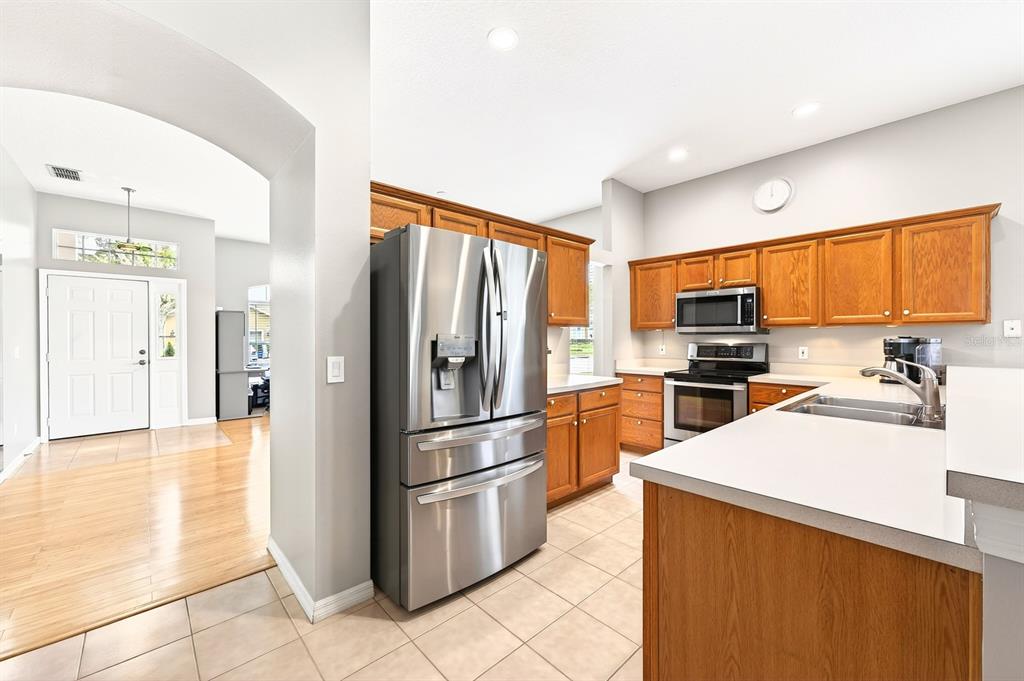 990 Ridgemount Place Lake Mary, FL 32746 - Photo 8 of 46 a kitchen with granite countertop a refrigerator and a sink