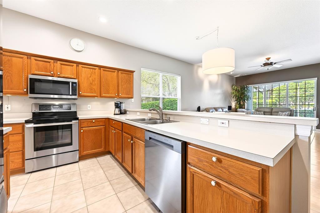 990 Ridgemount Place Lake Mary, FL 32746 - Photo 10 of 46 a kitchen with stainless steel appliances a sink stove and a refrigerator