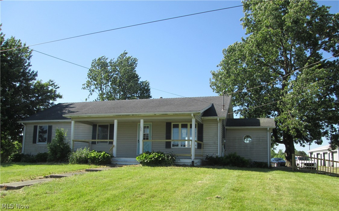 13096 Smith Road Wellington, OH 44090 - Photo 2 of 24 Ranch-style residence featuring light-colored siding and a covered front porch