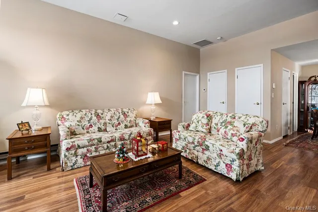 a living room with furniture and a lamp