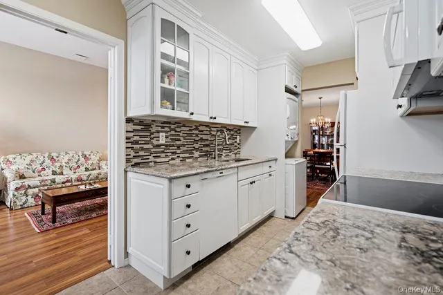 a kitchen with white cabinets and a stove