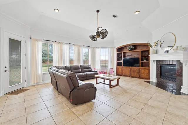 a living room with furniture a fireplace and a flat screen tv