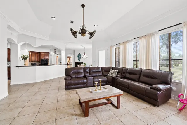 a living room with furniture and a chandelier