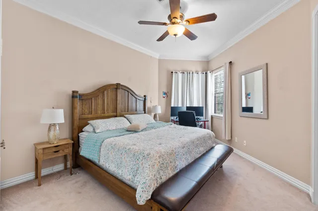 a bedroom with a large bed and a chandelier