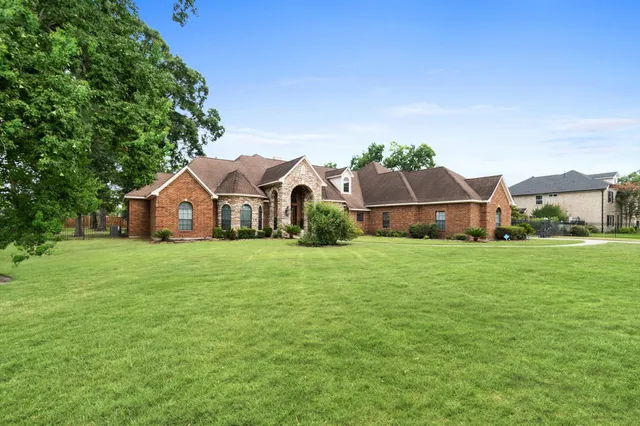 a front view of house with yard and green space