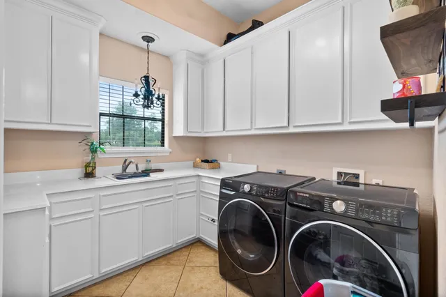 a utility room with sink dryer and washer