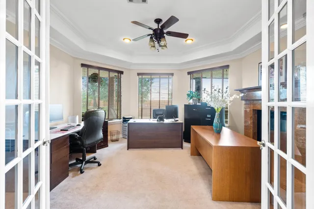 a living room with furniture and floor to ceiling windows