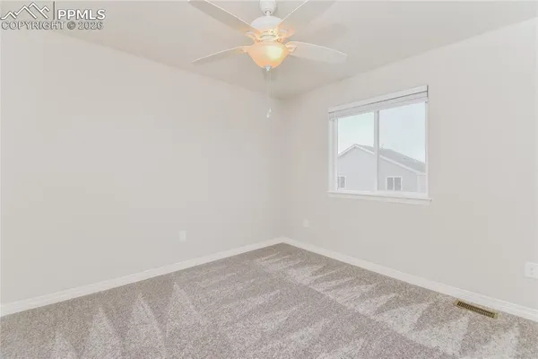an empty room with a window and closet