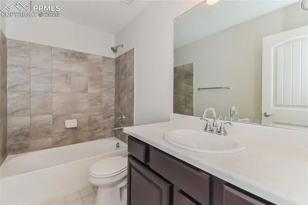 a bathroom with a sink a toilet a bathtub and shower
