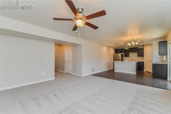 a view of a livingroom with a kitchen