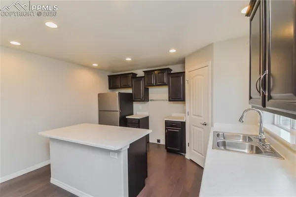 a kitchen with stainless steel appliances a microwave a sink and refrigerator