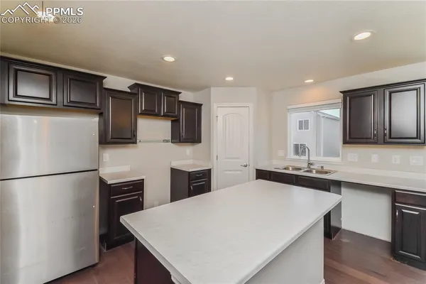 a kitchen with stainless steel appliances a refrigerator sink and microwave
