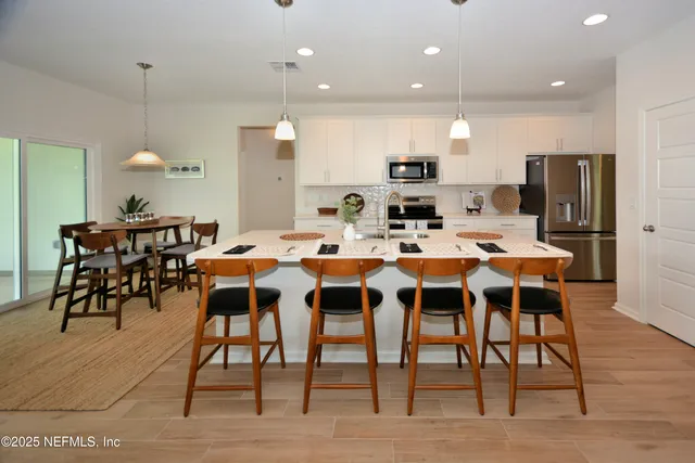 a large kitchen with a table and chairs