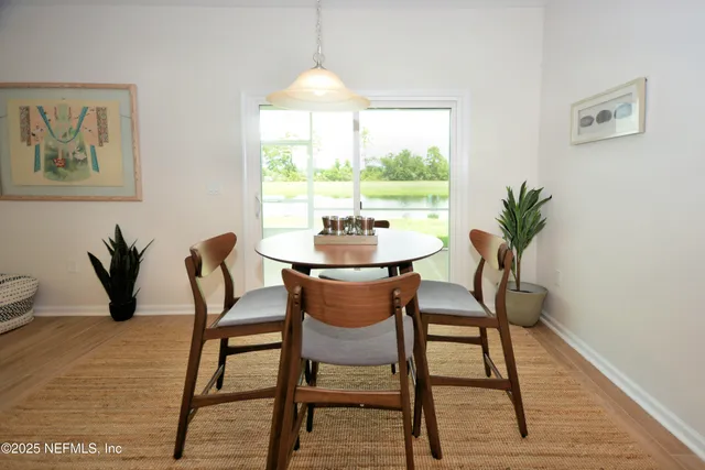 a dining room with furniture and window