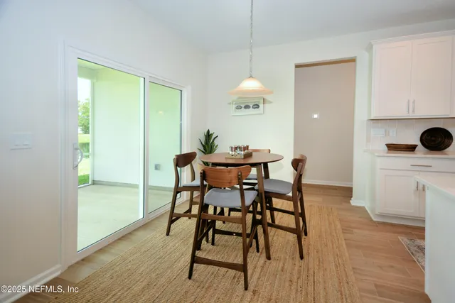 a dining room with furniture and wooden floor
