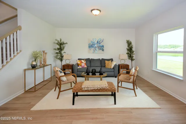 a living room with furniture and a potted plant