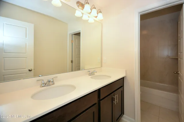 a bathroom with a sink double vanity and a mirror