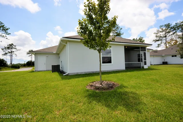 a front view of house with a garden