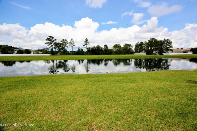 a view of a lake with houses in the back