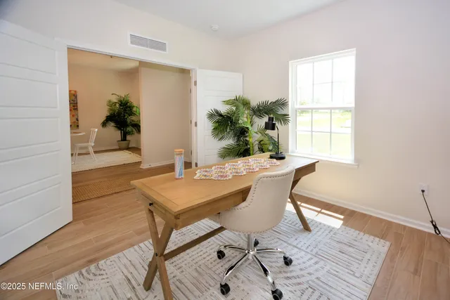 a view of a dining room with furniture and window
