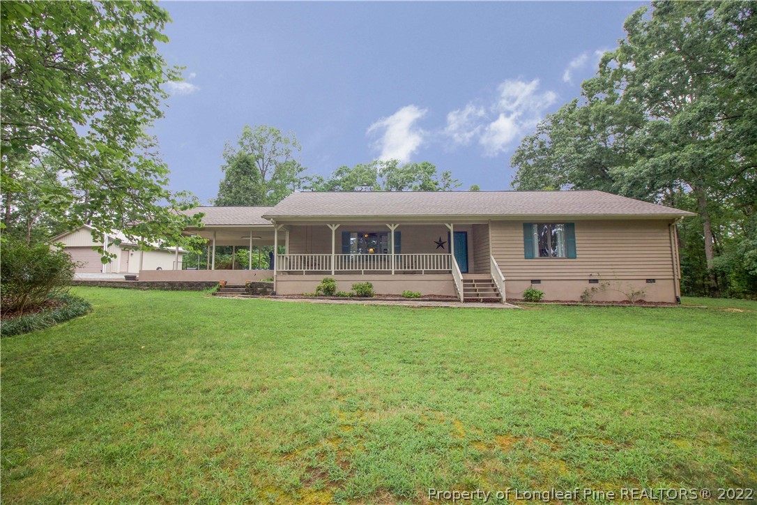 144 Manor Road Carthage, NC 28327 - Photo 1 of 47 a front view of a house with a garden