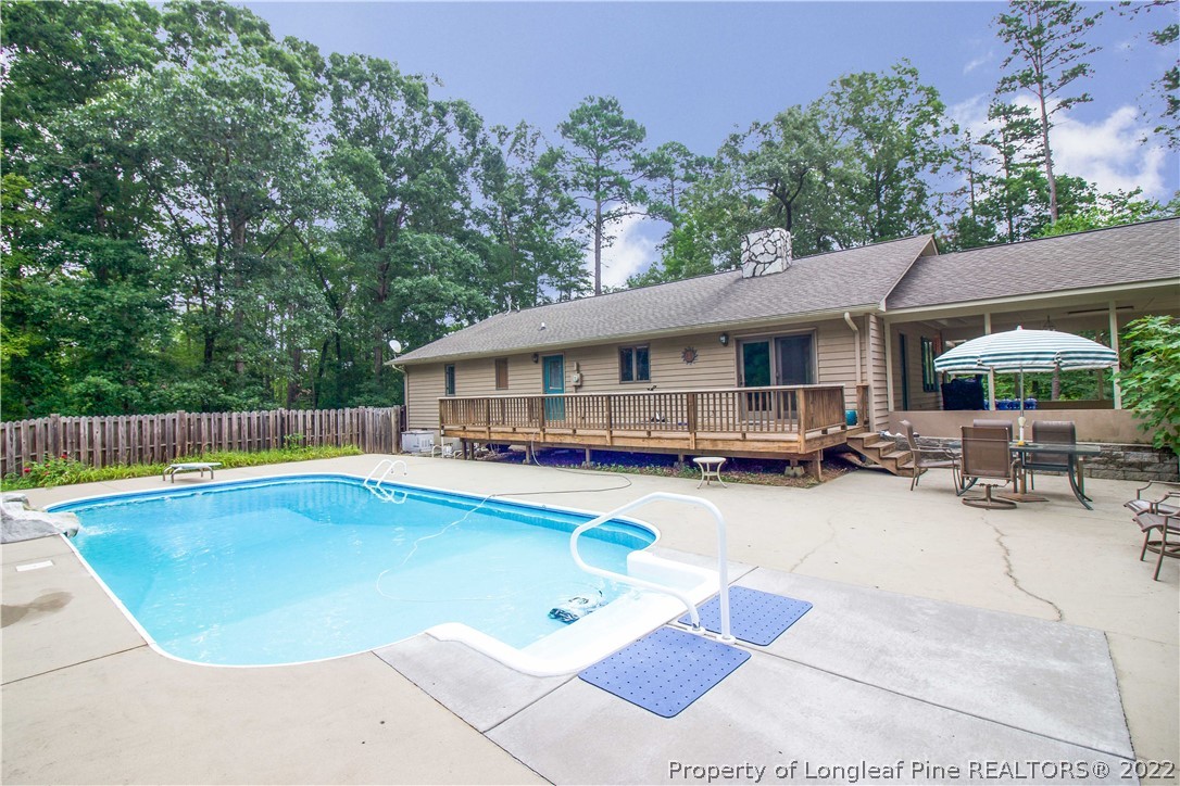 144 Manor Road Carthage, NC 28327 - Photo 18 of 47 a swimming pool with outdoor seating and yard