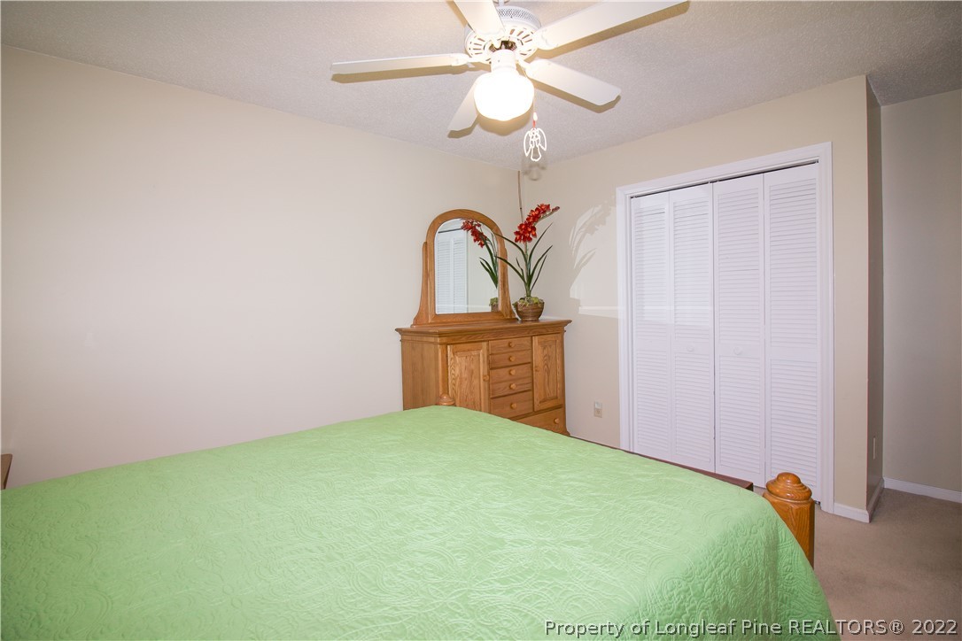 144 Manor Road Carthage, NC 28327 - Photo 29 of 47 a bedroom with a bed and a chandelier
