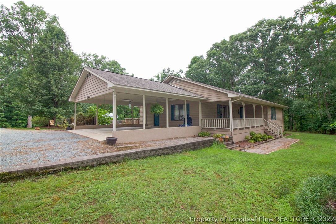 144 Manor Road Carthage, NC 28327 - Photo 3 of 47 a front view of house with a garden and patio