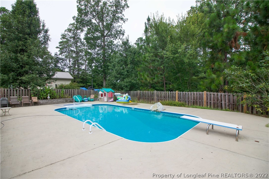 144 Manor Road Carthage, NC 28327 - Photo 32 of 47 a view of a swimming pool with a lounge chair