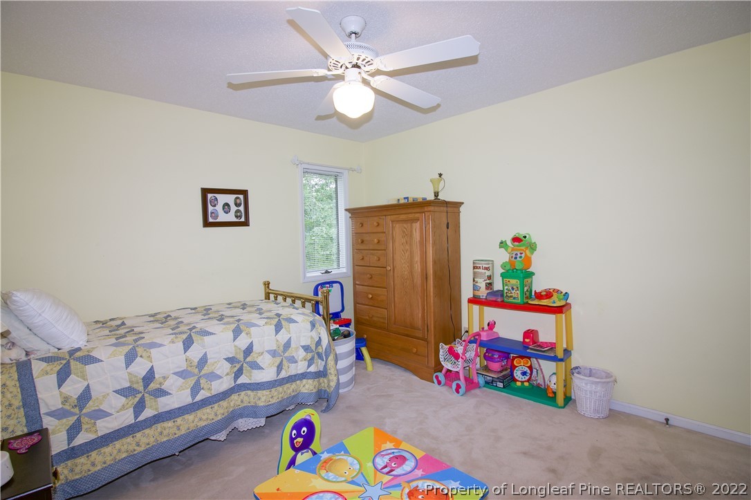 144 Manor Road Carthage, NC 28327 - Photo 36 of 47 a bedroom with a bed and a chandelier
