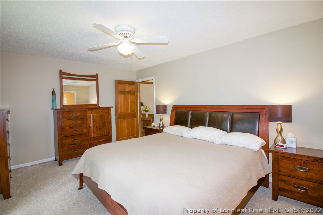 144 Manor Road Carthage, NC 28327 - Photo 37 of 47 a bedroom with a bed and dresser with mirror