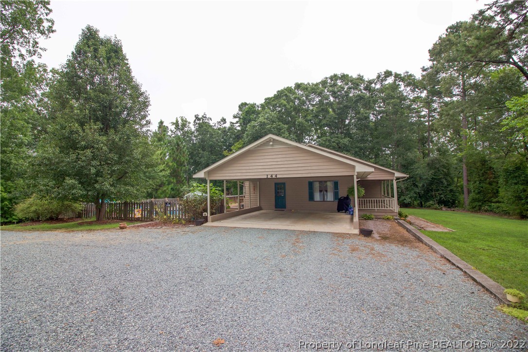 144 Manor Road Carthage, NC 28327 - Photo 4 of 47 a view of a house with a yard and large trees