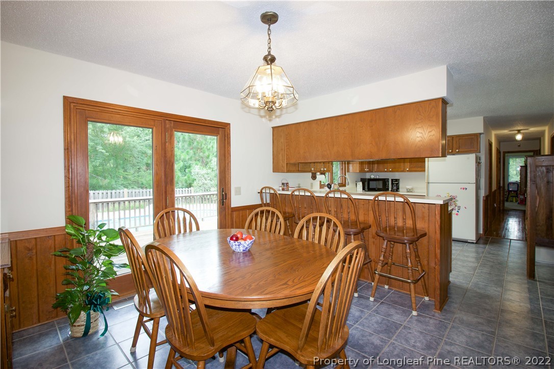 144 Manor Road Carthage, NC 28327 - Photo 42 of 47 a view of a dining room with furniture window and wooden floor