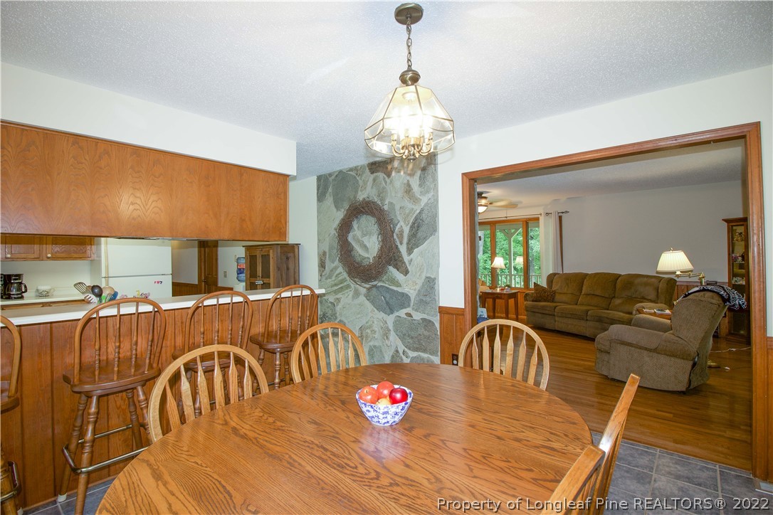 144 Manor Road Carthage, NC 28327 - Photo 45 of 47 a living room with furniture a chandelier and a table